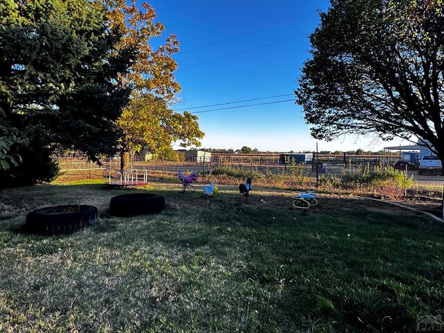 view of yard with a rural view and fence