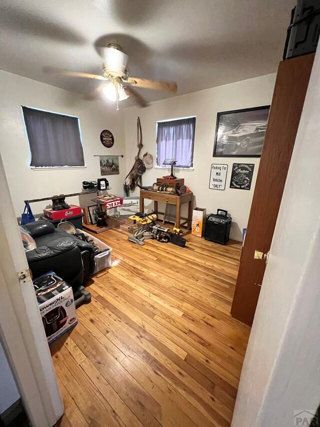 interior space featuring wood finished floors and a ceiling fan