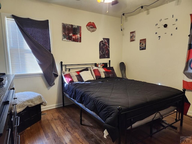 bedroom featuring dark wood-style floors and baseboards