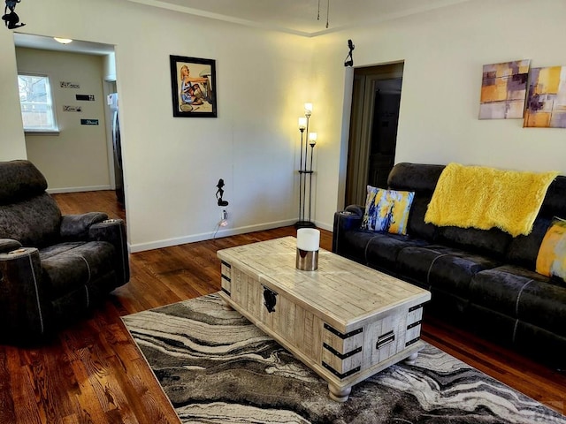 living area with dark wood finished floors and baseboards