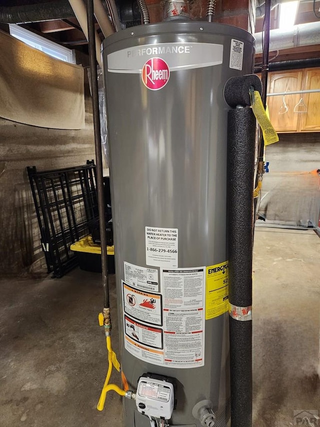 utility room featuring water heater