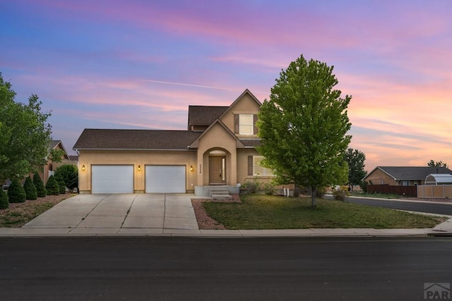 2330 Inspiration Ln, Pueblo, CO 81008 - view of front facade featuring stucco siding, driveway, and an attached garage