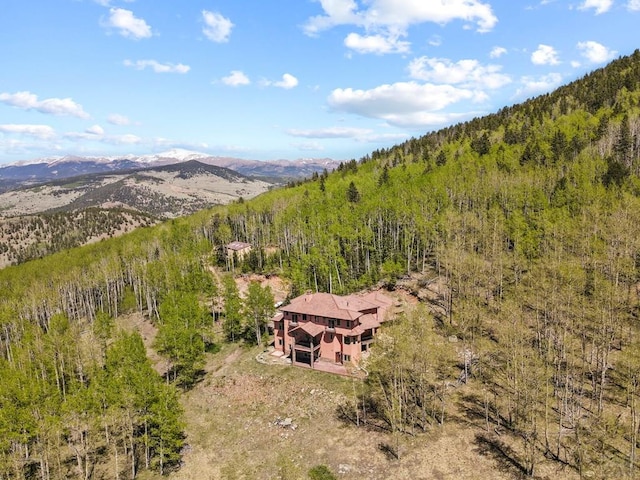 aerial view featuring a forest view and a mountain view