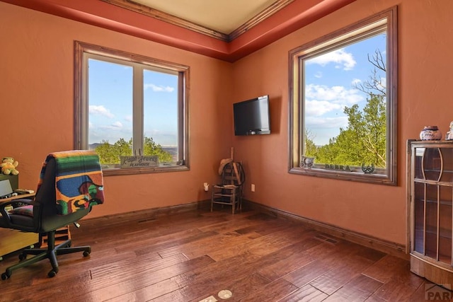 office space featuring ornamental molding, visible vents, baseboards, and wood finished floors