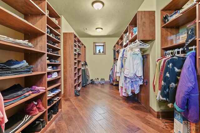 walk in closet with visible vents and wood finished floors