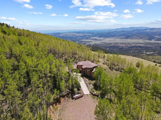 birds eye view of property with a forest view and a mountain view