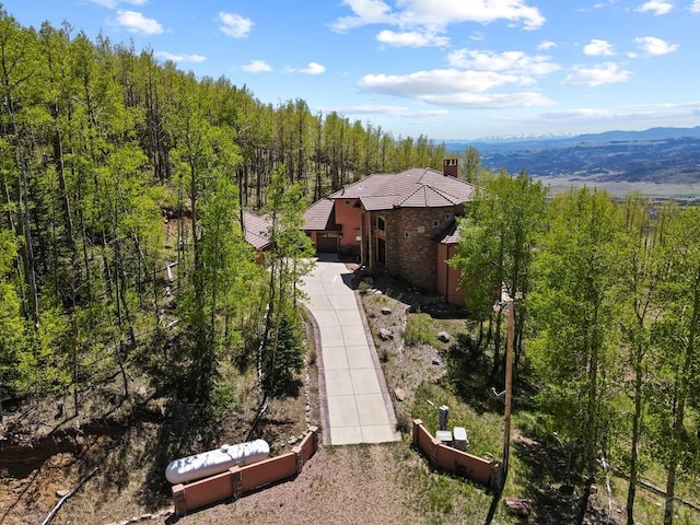 bird's eye view with a mountain view and a view of trees