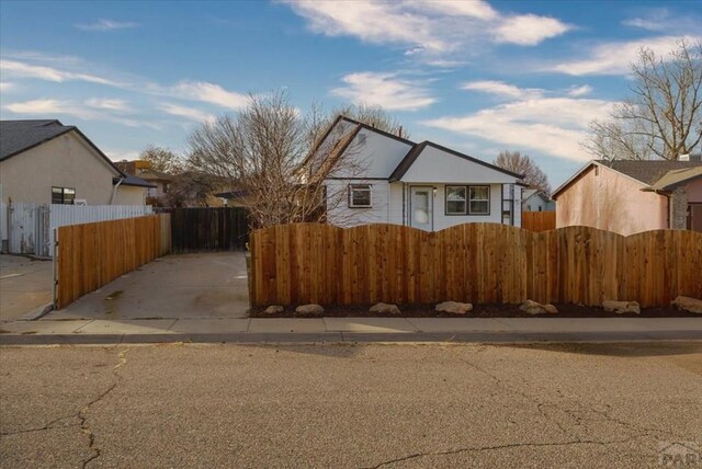 bungalow-style house with fence