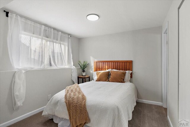 carpeted bedroom with baseboards