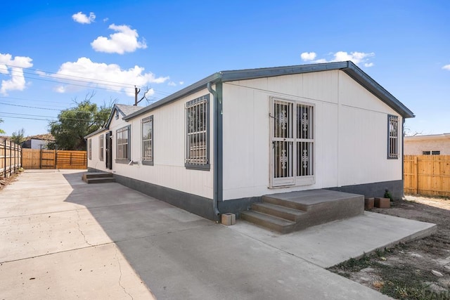 view of home's exterior featuring a fenced backyard and a patio