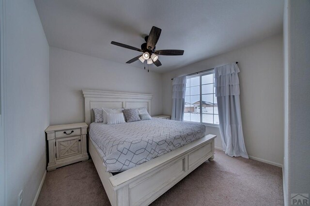 bedroom with carpet flooring, ceiling fan, and baseboards