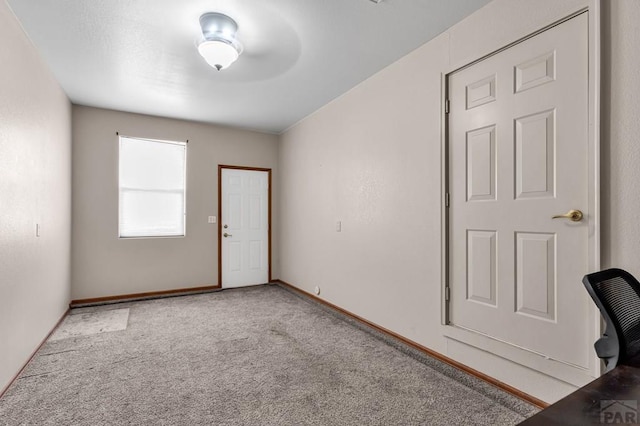 empty room with light carpet and baseboards