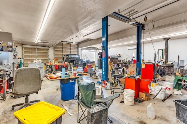 garage featuring an AC wall unit and a workshop area