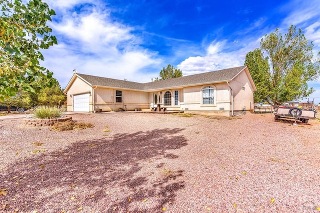 single story home featuring a garage, driveway, and stucco siding