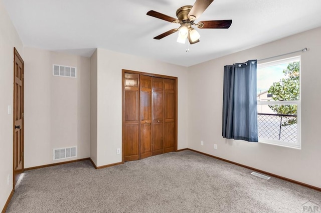 unfurnished bedroom featuring carpet, visible vents, and baseboards