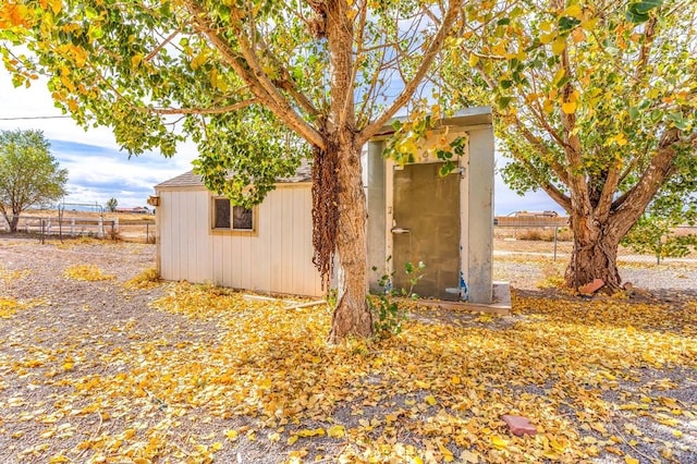 view of shed featuring fence