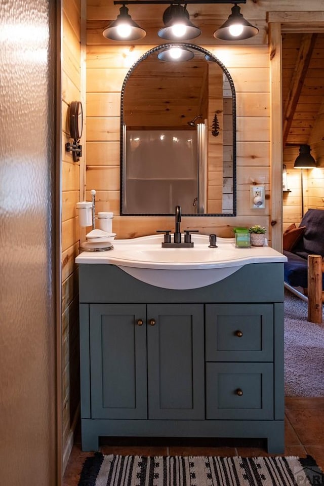 317 Parsons Rd, La Veta, CO 81055 - bathroom with wood walls, vanity, and tile patterned flooring