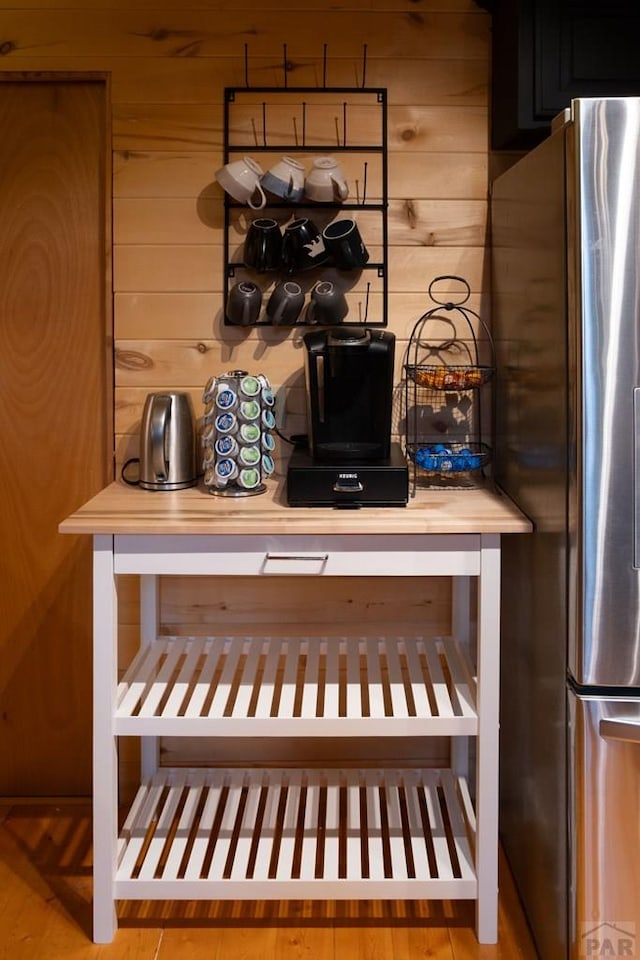 317 Parsons Rd, La Veta, CO 81055 - kitchen view of freestanding refrigerator, wood walls, and light countertops