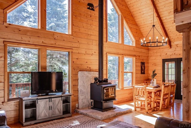 317 Parsons Rd, La Veta, CO 81055 - living area featuring wooden ceiling, wooden walls, plenty of natural light, a wood stove, and a chandelier