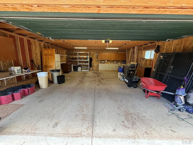 317 Parsons Rd, La Veta, CO 81055 - garage with freestanding refrigerator and a garage door opener