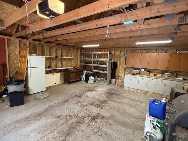 317 Parsons Rd, La Veta, CO 81055 - garage with freestanding refrigerator and a garage door opener
