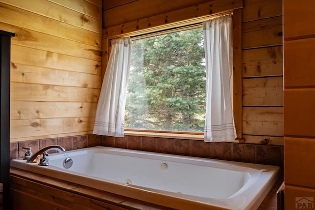317 Parsons Rd, La Veta, CO 81055 - bathroom with healthy amount of natural light, a jetted tub, and wooden walls