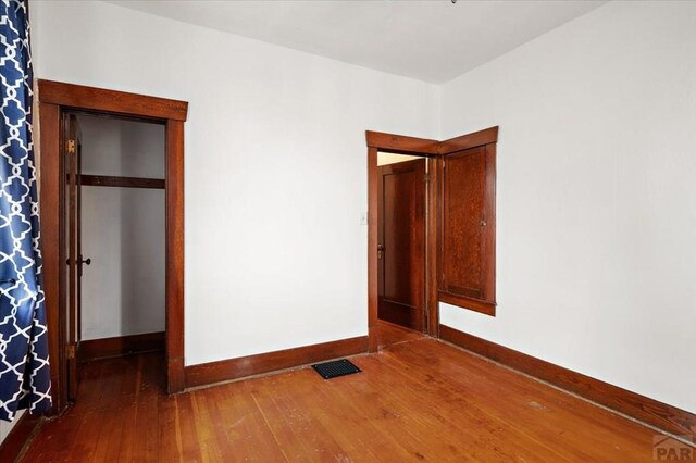 423 Washington St, Pueblo, CO 81004 - unfurnished bedroom featuring hardwood / wood-style flooring and baseboards