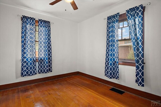 423 Washington St, Pueblo, CO 81004 - empty room featuring hardwood / wood-style flooring, ceiling fan, and baseboards