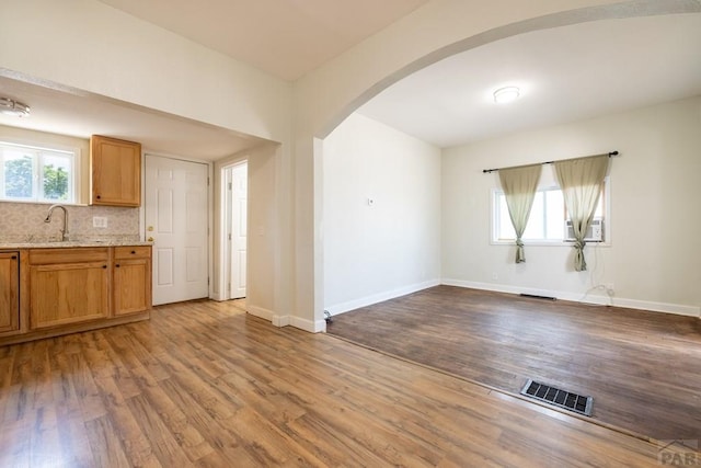 212 W Summit Ave, Pueblo, CO 81004 - unfurnished living room with arched walkways and wood finished floors