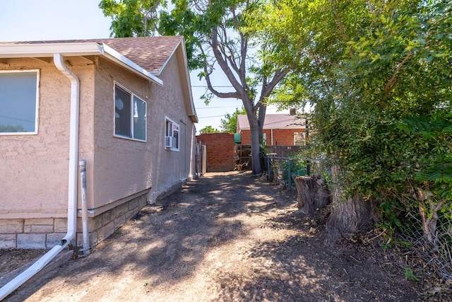 212 W Summit Ave, Pueblo, CO 81004 - view of side of home featuring a shingled roof and stucco siding