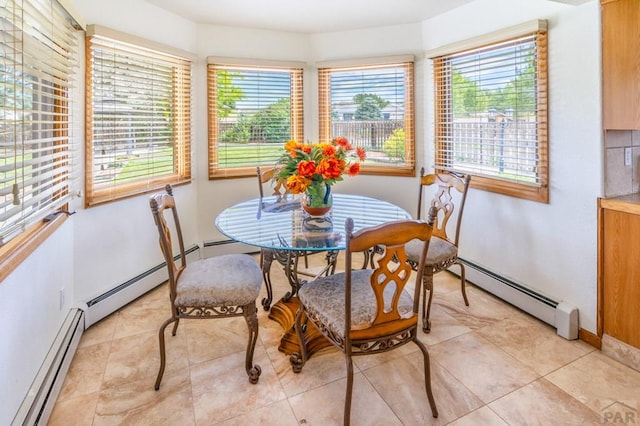 dining space featuring a baseboard heating unit and baseboards