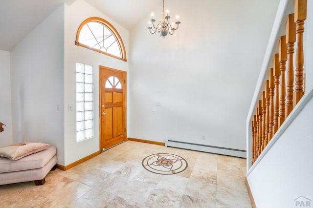 foyer entrance with a notable chandelier, a baseboard radiator, baseboards, and a wealth of natural light