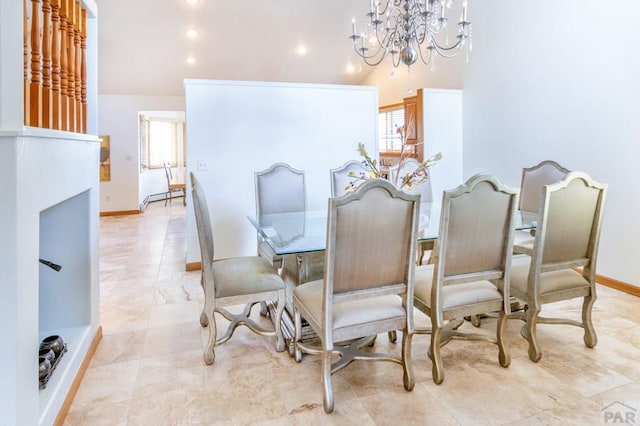 dining area featuring lofted ceiling, baseboard heating, baseboards, and a notable chandelier