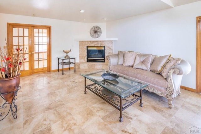 living area featuring recessed lighting, baseboards, french doors, and a high end fireplace