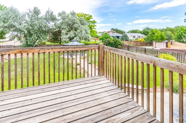 wooden terrace with a fenced backyard and a yard