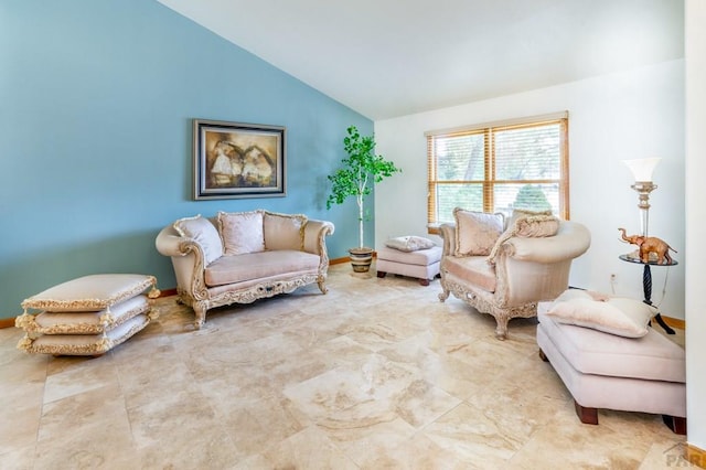 sitting room with baseboards and vaulted ceiling