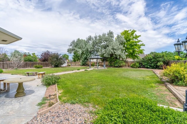 view of yard with a patio area, a fenced backyard, and a gazebo