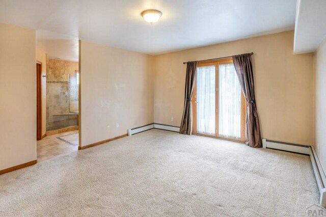 spare room featuring light carpet, a baseboard radiator, and baseboards