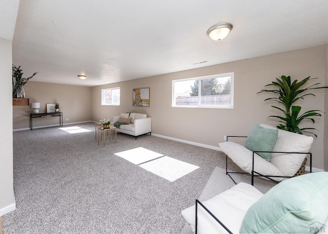 sitting room featuring carpet floors, visible vents, and baseboards