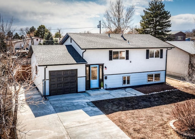 view of front of house featuring a garage, driveway, roof with shingles, and stucco siding