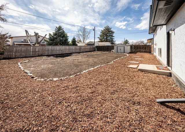 view of yard featuring a fenced backyard, an outdoor structure, and a shed