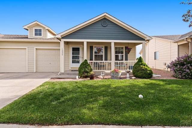 1224 Silver Hawk Ct, Pueblo, CO 81008 - ranch-style house featuring a porch, a garage, driveway, and a front lawn