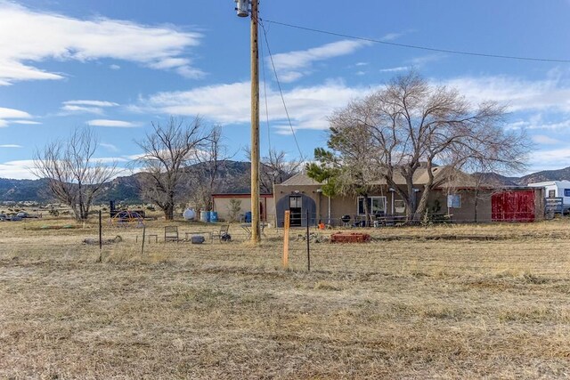 ranch-style home with a mountain view and stucco siding