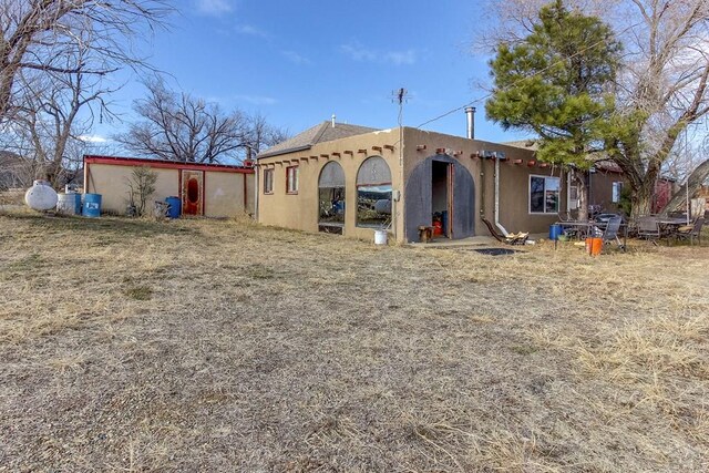 rear view of house with stucco siding