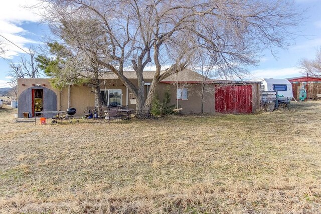 view of front of house featuring a front lawn and stucco siding