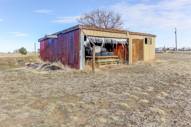 view of outdoor structure featuring a rural view