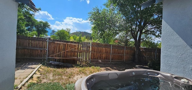 view of yard featuring fence and a gate