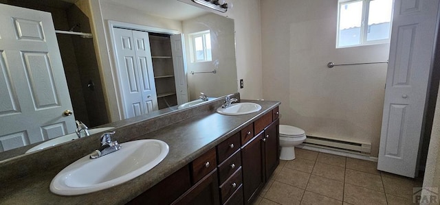 full bath with a baseboard radiator, a closet, a sink, and tile patterned floors