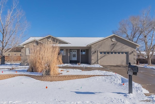 ranch-style house featuring driveway, a garage, and stucco siding