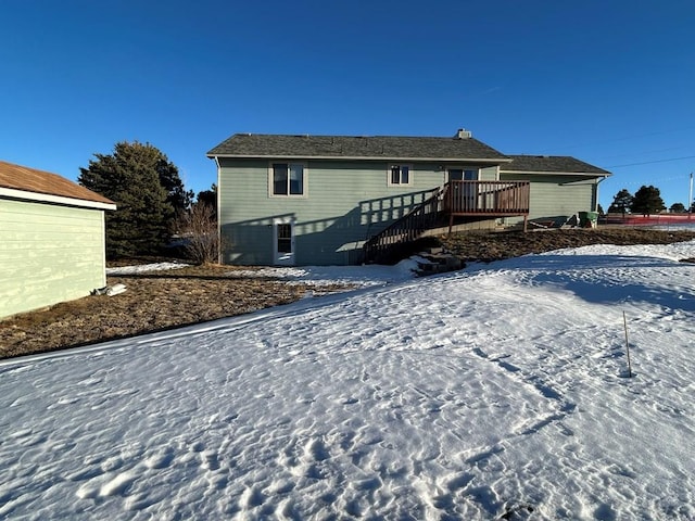 15840 Teak Pl, Elbert, CO 80106 - snow covered house featuring a wooden deck and stairway